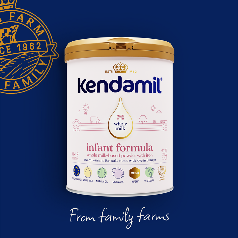 Kendamil infant formula container on a blue background with brand logo.